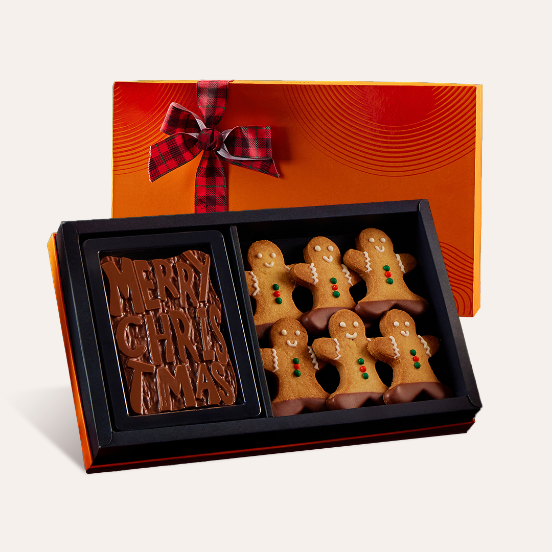 A Merry Christmas chocolate gift box with a walnut brownie fudge bar and gingerbread cookies. 
