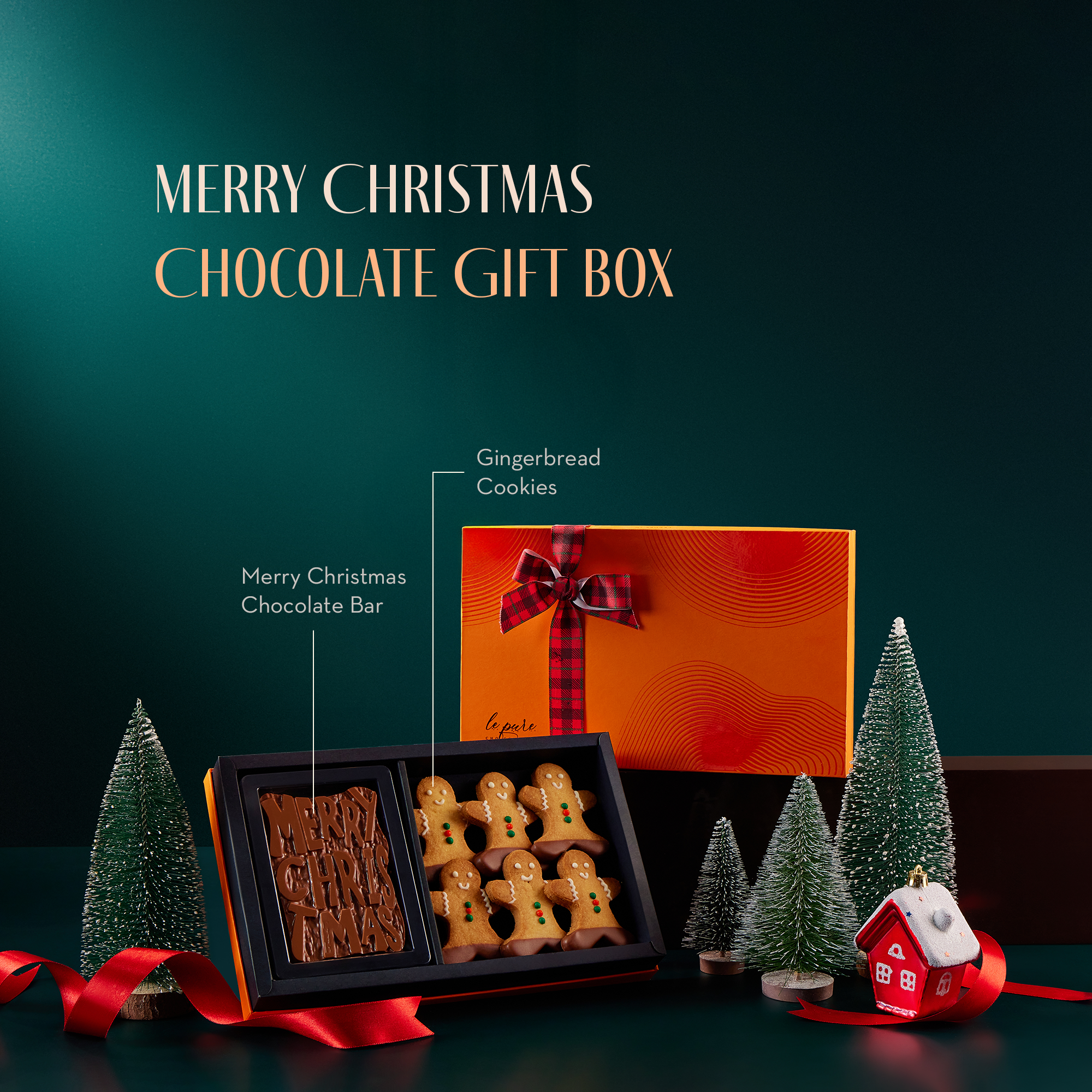 A Merry Christmas chocolate gift box with a walnut brownie fudge bar and gingerbread cookies.